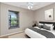 Relaxing bedroom featuring neutral tones, a ceiling fan, and a large window view at 3455 Countryside Blvd # 31, Clearwater, FL 33761