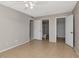 Bright bedroom with tile flooring, a ceiling fan, and an ensuite bathroom at 3455 Countryside Blvd # 31, Clearwater, FL 33761