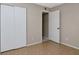 Neutral bedroom with tile flooring, closet and open door leading to additional storage space at 3455 Countryside Blvd # 31, Clearwater, FL 33761