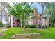 Multi-story building with landscaped lawn and tree at 3455 Countryside Blvd # 31, Clearwater, FL 33761