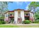 Inviting condo building with balconies, lush landscaping, and a well-maintained lawn at 3455 Countryside Blvd # 31, Clearwater, FL 33761