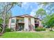 Well-maintained condo building with balconies, lush landscaping, and well-kept green lawn at 3455 Countryside Blvd # 31, Clearwater, FL 33761