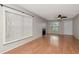 Spacious living room with wood floors, fireplace, ceiling fan, window, and a white front door at 3455 Countryside Blvd # 31, Clearwater, FL 33761