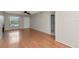 Open living room featuring wood floors, fireplace, ceiling fan, front door, and access to the bathroom at 3455 Countryside Blvd # 31, Clearwater, FL 33761