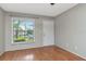 Inviting living room with wood floors, a window, and a white front door providing a welcoming entrance at 3455 Countryside Blvd # 31, Clearwater, FL 33761