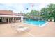 Inviting community pool with plenty of lounge chairs for relaxing in the sun and enjoying the outdoors at 3455 Countryside Blvd # 31, Clearwater, FL 33761