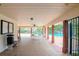 Community pool featuring an indoor recreation area with tables, chairs, and ceiling fan at 3455 Countryside Blvd # 31, Clearwater, FL 33761