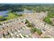 A stunning aerial shot showcasing a Gathering home in a vibrant neighborhood with a picturesque lake view nearby at 36557 Night Strawberry Ct, Dade City, FL 33525