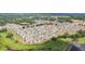 A picturesque aerial view captures a neighborhood nestled amidst greenery, with a tranquil lake adding to the scenic beauty at 36557 Night Strawberry Ct, Dade City, FL 33525