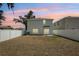 Home backyard with white privacy fence at dusk at 36557 Night Strawberry Ct, Dade City, FL 33525