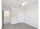 A well-lit bedroom features neutral walls, a ceiling fan, and plush carpeting at 36557 Night Strawberry Ct, Dade City, FL 33525