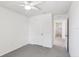 Bedroom featuring a ceiling fan and an adjoining room through an open door at 36557 Night Strawberry Ct, Dade City, FL 33525