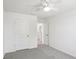 A well-lit bedroom with neutral walls, a ceiling fan, and carpeted floors at 36557 Night Strawberry Ct, Dade City, FL 33525