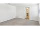 A bright bedroom features neutral carpet and white trim, with a bathroom accessible through an open door at 36557 Night Strawberry Ct, Dade City, FL 33525