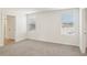 This bedroom boasts ample natural light through its windows, complemented by neutral carpeting and wall color at 36557 Night Strawberry Ct, Dade City, FL 33525