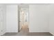 Bedroom with neutral walls and carpeting, with an open doorway leading to more living space at 36557 Night Strawberry Ct, Dade City, FL 33525