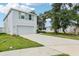 View of home featuring a two-car garage, lawn, and mature tree at 36557 Night Strawberry Ct, Dade City, FL 33525
