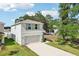 Inviting home features a two-car garage, fresh landscaping, and a sunny facade, perfect for a growing Gathering at 36557 Night Strawberry Ct, Dade City, FL 33525