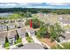 A charming two-story home with a well-manicured lawn and a view of the community lake at 36557 Night Strawberry Ct, Dade City, FL 33525
