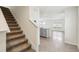 Foyer with carpeted staircase, and open access to living areas at 36557 Night Strawberry Ct, Dade City, FL 33525