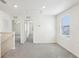 Upstairs hallway featuring neutral carpet, white walls, multiple doorways, and a bright window at 36557 Night Strawberry Ct, Dade City, FL 33525