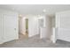 Carpeted hallway featuring several doors leading to bathrooms and bedrooms at 36557 Night Strawberry Ct, Dade City, FL 33525