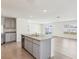 Kitchen island with stainless steel sink, granite countertops, and gray cabinets, tile flooring at 36557 Night Strawberry Ct, Dade City, FL 33525