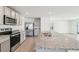 Gray cabinets and granite countertops accent this kitchen with stainless steel appliances and tile flooring at 36557 Night Strawberry Ct, Dade City, FL 33525