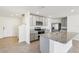 Well-lit kitchen showcases stainless steel appliances, granite countertops, and gray cabinets at 36557 Night Strawberry Ct, Dade City, FL 33525