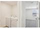 Laundry area with washer and dryer, located off the upstairs hallway and near the bedroom at 36557 Night Strawberry Ct, Dade City, FL 33525