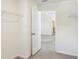 Open walk-in closet leads to bedroom, featuring ventilated shelving and neutral carpet at 36557 Night Strawberry Ct, Dade City, FL 33525