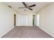 Bright bedroom featuring neutral walls, carpet, closet, and a ceiling fan at 3719 Greenford St, Valrico, FL 33596