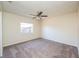 Bedroom featuring neutral walls, carpet, ceiling fan, and natural light from the window at 3719 Greenford St, Valrico, FL 33596