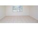 Clean bedroom with tile flooring and natural light from a window at 3719 Greenford St, Valrico, FL 33596