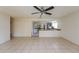 Bright living room showcasing tile flooring and a glimpse of the eat-in kitchen at 3719 Greenford St, Valrico, FL 33596