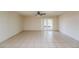Open living area features neutral tile flooring and access to the outdoor patio at 3719 Greenford St, Valrico, FL 33596