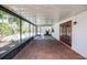 Enclosed patio with tile flooring, views of the pool, and access to the yard at 3719 Greenford St, Valrico, FL 33596