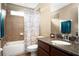 Traditional bathroom featuring granite counters, wood vanity and tiled shower at 4407 Scarlet Loop, Wesley Chapel, FL 33544