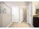 This bathroom features a walk-in shower with glass enclosure, tile floors and two entry doors at 4407 Scarlet Loop, Wesley Chapel, FL 33544