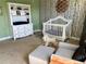 Charming Bedroom with a crib, rocking chair, and stylish wallpaper at 4407 Scarlet Loop, Wesley Chapel, FL 33544