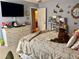 Well-lit bedroom with a dresser, television, and decorative accents at 4407 Scarlet Loop, Wesley Chapel, FL 33544
