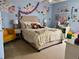 This bedroom features carpeted floors, stylish decor, and a comfortable bed and furnishings at 4407 Scarlet Loop, Wesley Chapel, FL 33544