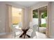 Bright breakfast nook with glass table set and views to the lanai through sliding glass doors at 4407 Scarlet Loop, Wesley Chapel, FL 33544