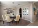 Elegant dining room featuring stylish decor, a modern light fixture, and seating for six at 4407 Scarlet Loop, Wesley Chapel, FL 33544