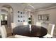 Dining area with modern chandelier, dark wood table, and seating for six, open to the kitchen at 4407 Scarlet Loop, Wesley Chapel, FL 33544