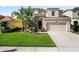 Beautiful home with a well-manicured lawn, stone accents, and a spacious driveway leading to the garage at 4407 Scarlet Loop, Wesley Chapel, FL 33544