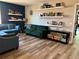 This modern living room features floating shelves, beautiful furniture and luxury vinyl plank floors at 4407 Scarlet Loop, Wesley Chapel, FL 33544