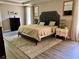 Relaxing main bedroom with tray ceiling, neutral walls, wood floors, and ensuite bathroom at 4407 Scarlet Loop, Wesley Chapel, FL 33544