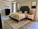 This bedroom features a spacious layout, wood floors, a tray ceiling, neutral paint and decorative accents at 4407 Scarlet Loop, Wesley Chapel, FL 33544