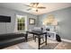 Comfortable office with a desk, sofa, and natural light from window at 4407 Scarlet Loop, Wesley Chapel, FL 33544
